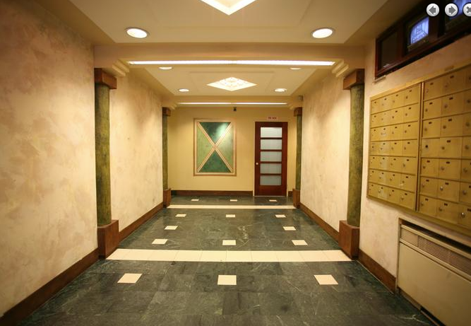 a hallway with lockers and a door in a building